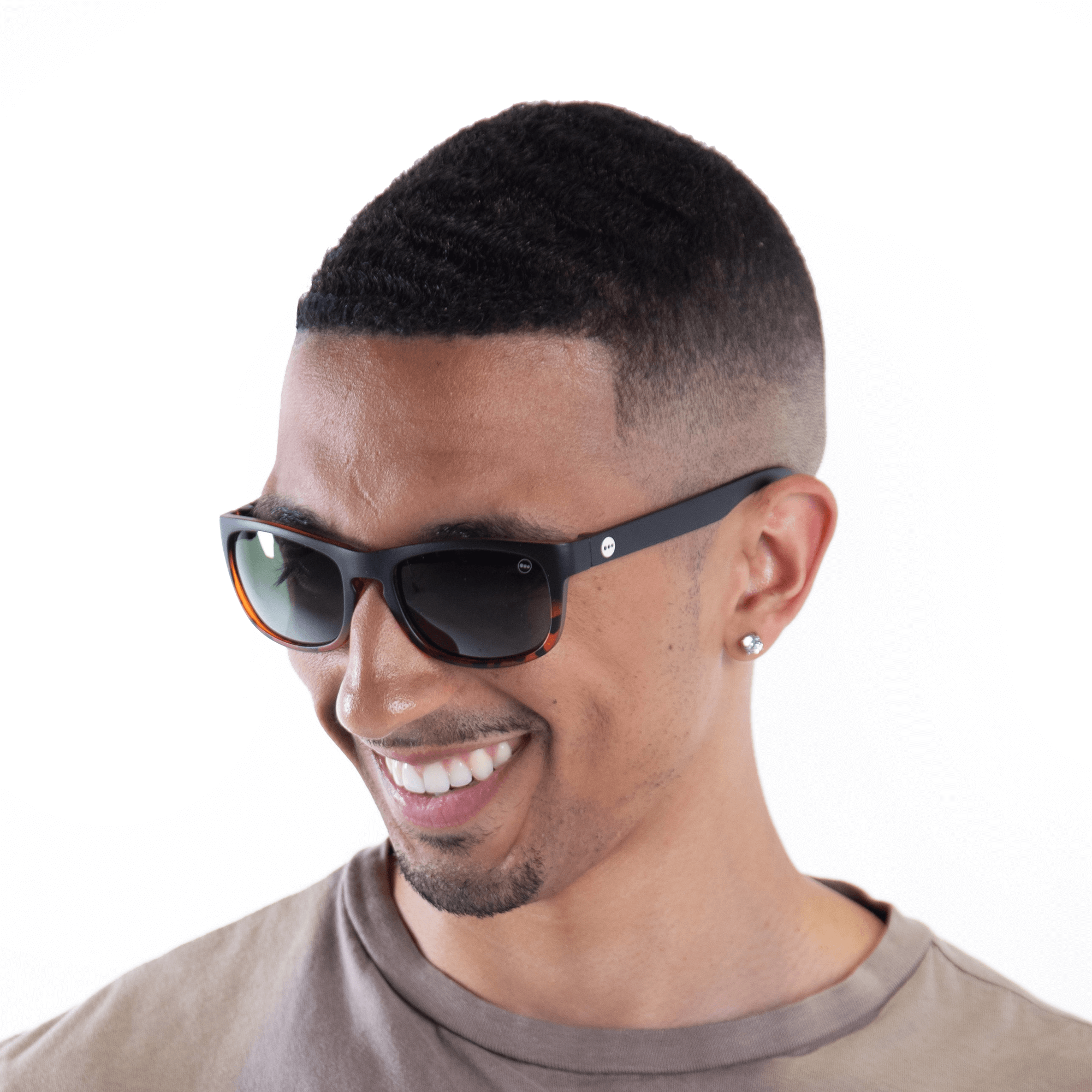 A male model wearing Sugar Kiwi sunglasses, size small.